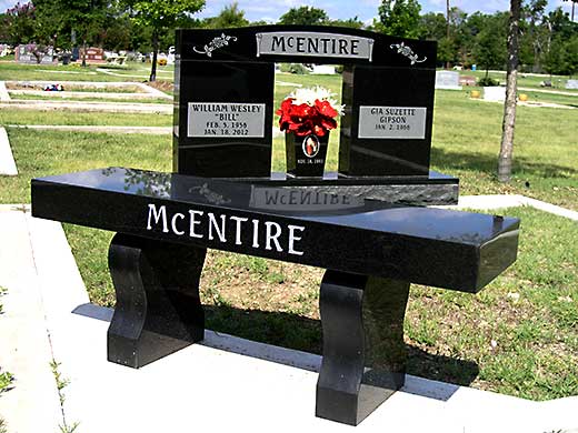 Black marble memorial setting with double-width stone, matching vase and custom bench